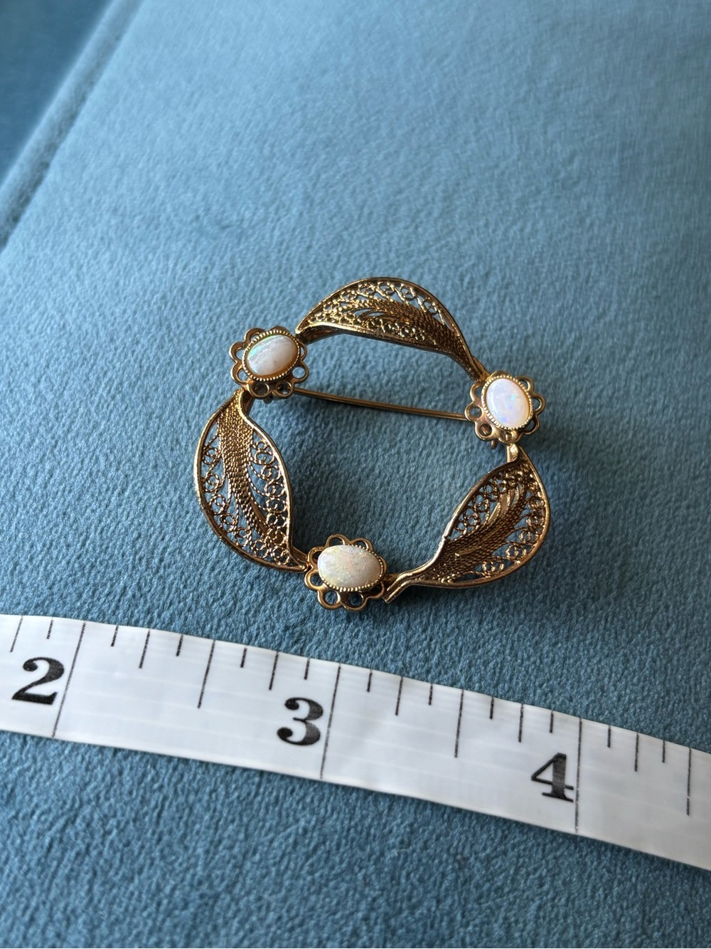 Vintage mid-century gold tone filigree brooch with three opal-like stones